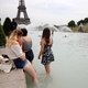 People cool off in the Trocadero fountains across from the Eiffel Tower in Paris, France, on June 24.